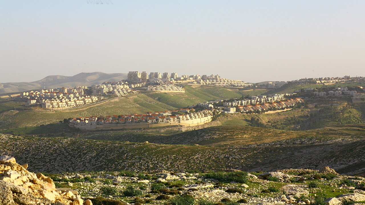 White buildings and red-roofed homes spread across the hills of Ma’ale Adumim.